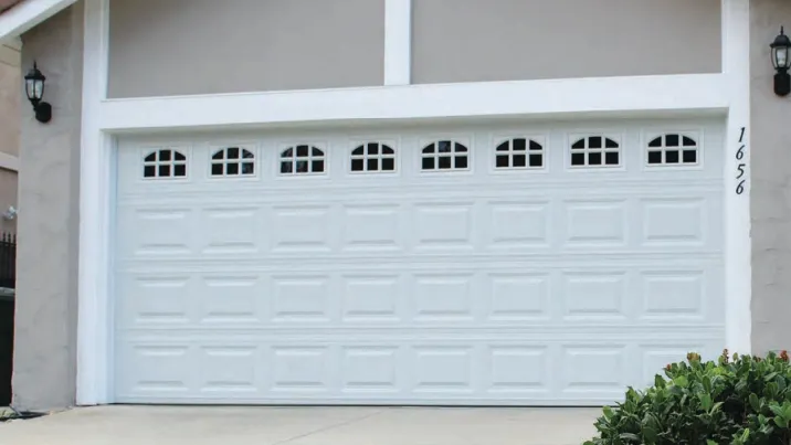 White carriage-style garage door with arched windows in Austin TX
